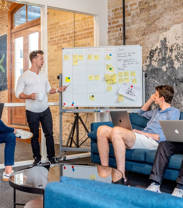 Team members engaged in strategic planning and brainstorming session for the construction service